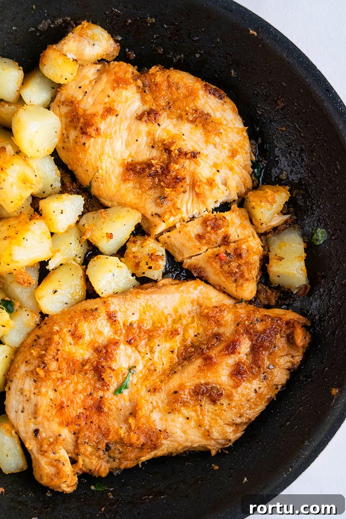 One-Pot Roast Chicken and Potatoes Recipe for Simple Weeknight Meals 3 Sliced Chicken Breast and Potatoes in a Black Pan