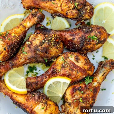 Square image of lemon pepper chicken drumsticks.