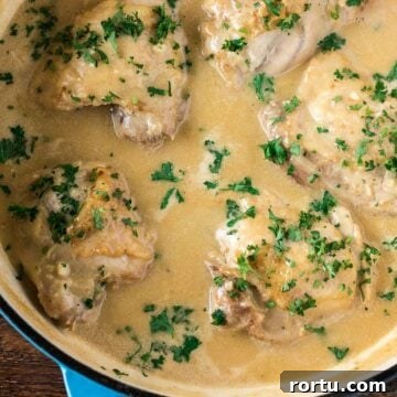 Chicken in White Sauce in a cast iron braiser.