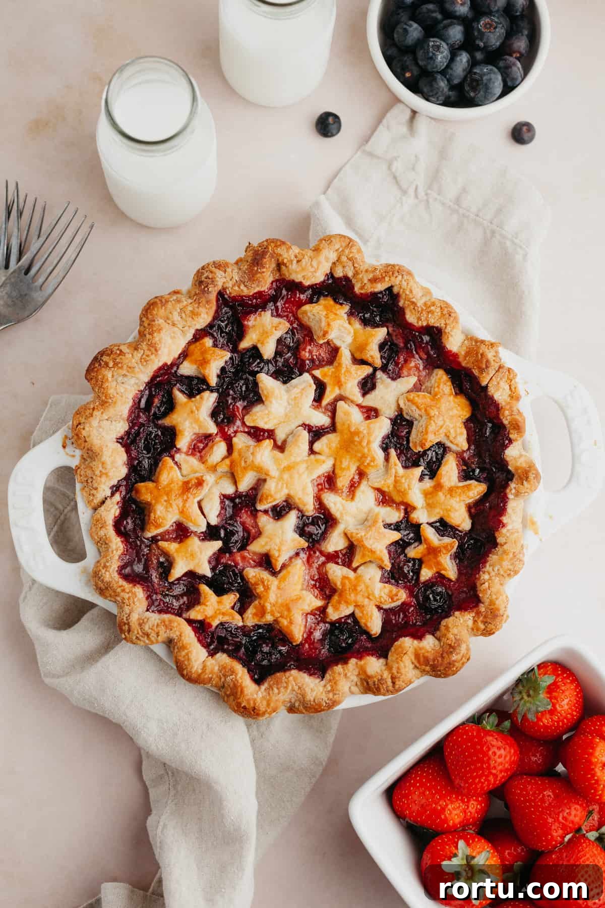 Strawberry and Blueberry Summer Pie Recipe: Fresh Berry Tart 2 A mixed berry pie covered in star pastry cutouts.