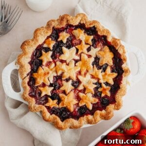 Strawberry and Blueberry Summer Pie Recipe: Fresh Berry Tart 16 A mixed berry pie covered in star pastry cutouts.