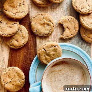 gingerbread cookies on wood tray next to cup of coffee