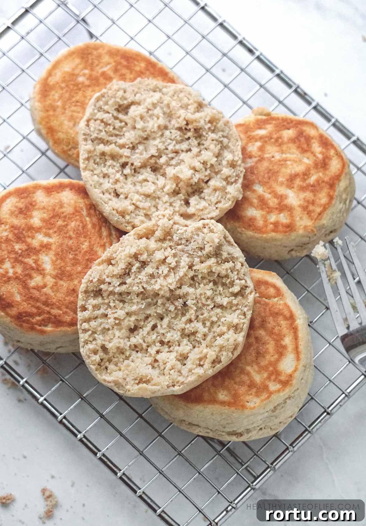 Gluten-free sourdough English muffins vegan no yeast no egg - fork split  showing nooks and crannies - overhead shot