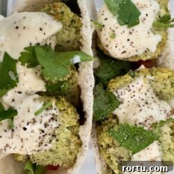 Crispy air fryer falafel served with pita, garlic sauce, and fresh herbs.