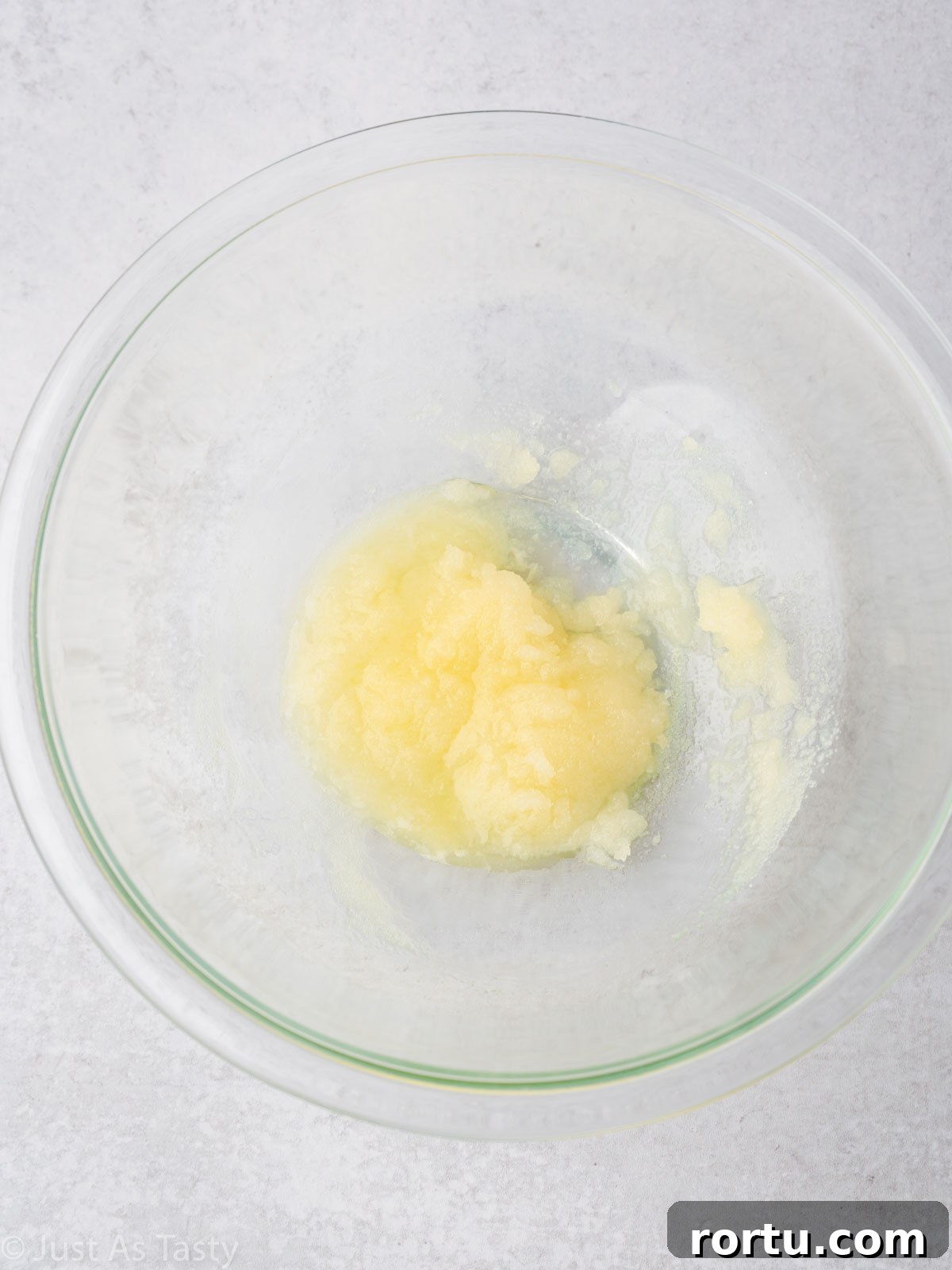 Melted butter and sugar in a bowl.