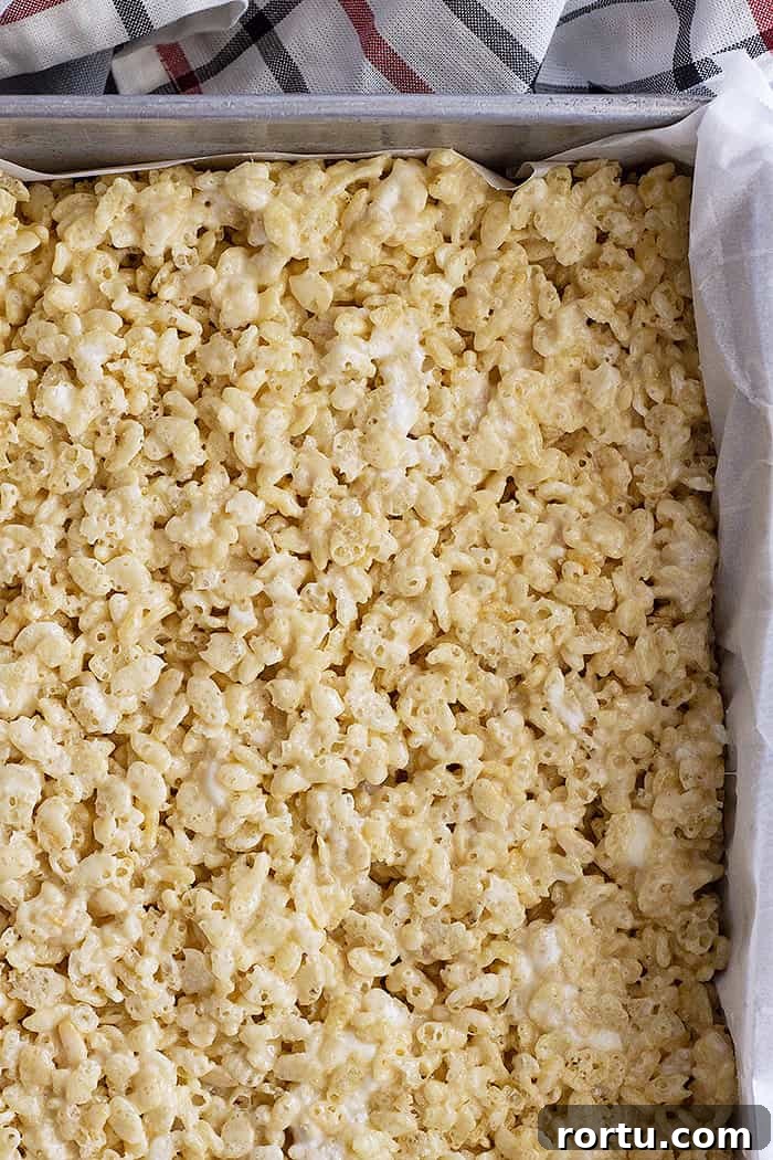Homemade Gooey Rice Krispie Treats for Perfect Snacktime 4 A pan of rice kirspie treats waiting to be cut into bars.