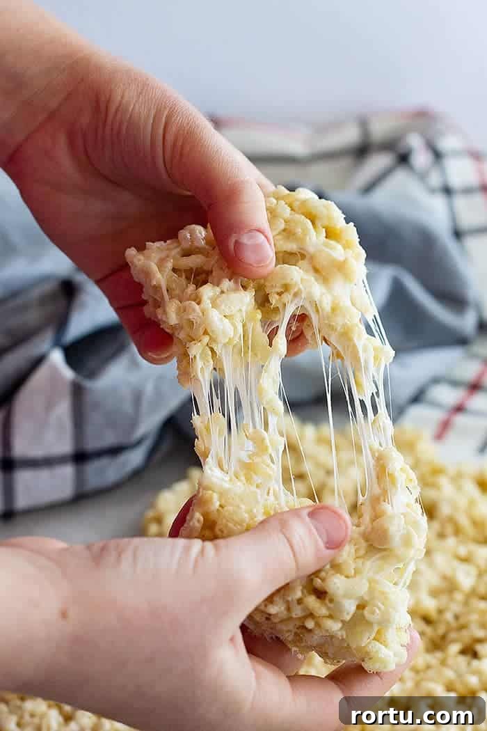 Homemade Gooey Rice Krispie Treats for Perfect Snacktime 5 pulling apart a soft rice krispie treat