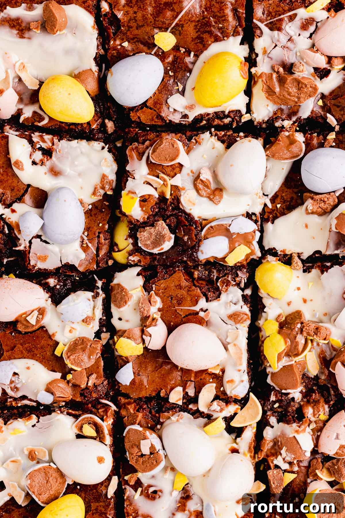 Mini Egg Chocolate Brownies with Melted Candy Centers 13 brownies with smeared white chocolate and crushed chocolate mini eggs on top