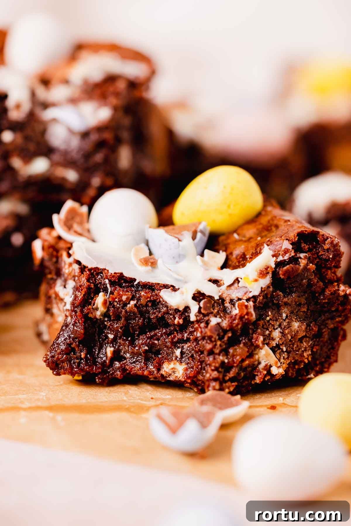Mini Egg Chocolate Brownies with Melted Candy Centers 14 bitten mini egg brownie square with mini eggs on top