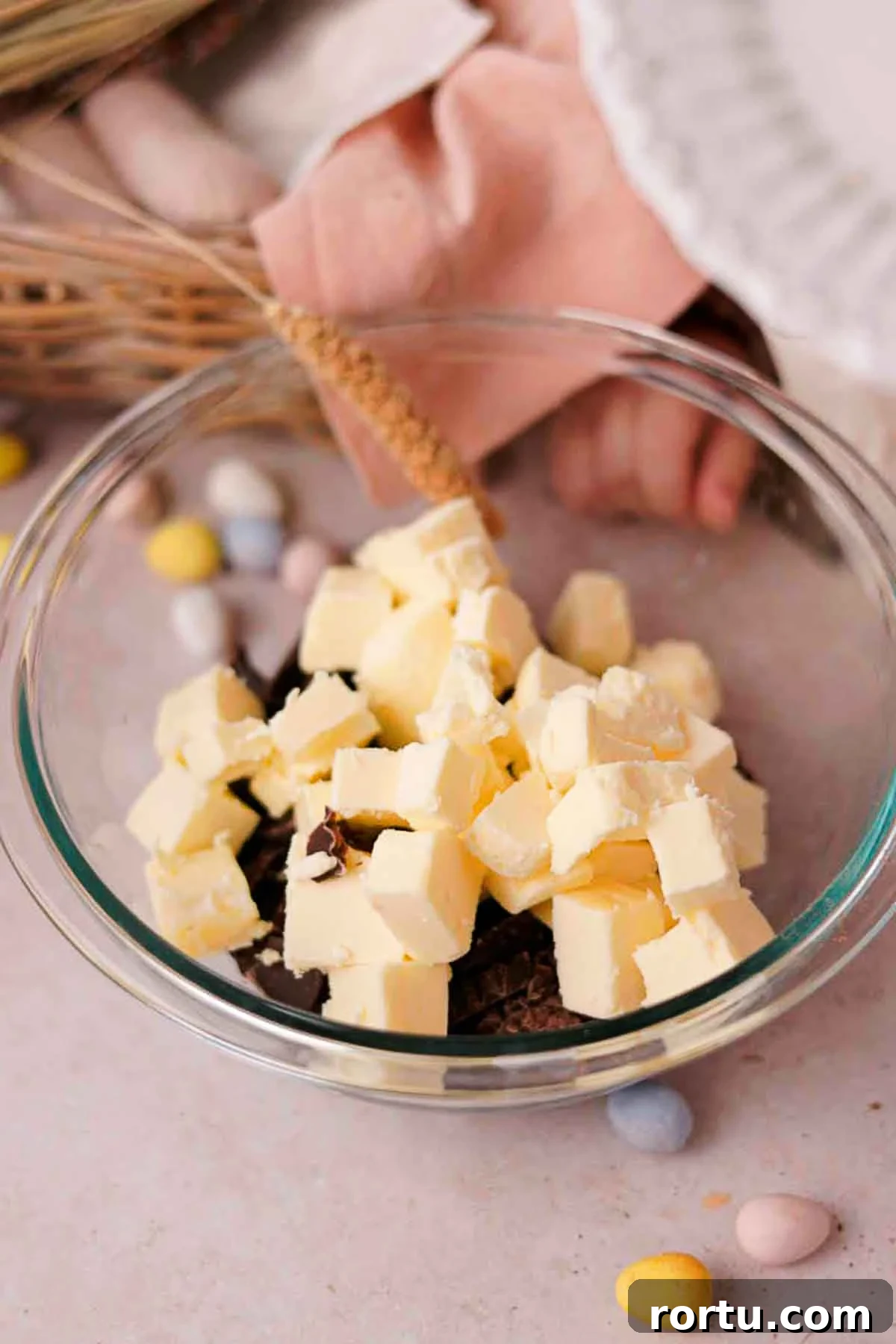 Mini Egg Chocolate Brownies with Melted Candy Centers 5 combining cubed butter and chocolate in glass bowl