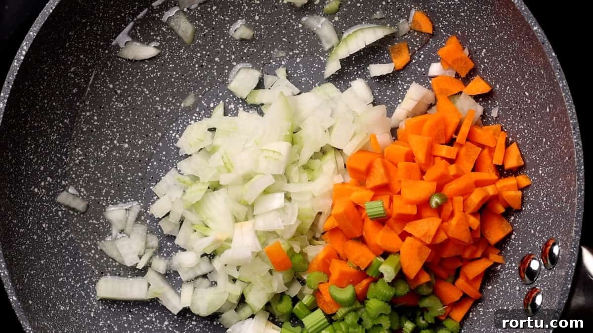 Lamb Ragu Recipe: Slow-Simmered Sauce with Parmesan 5 Diced onion carrot and celery added to olive oil in skillet.