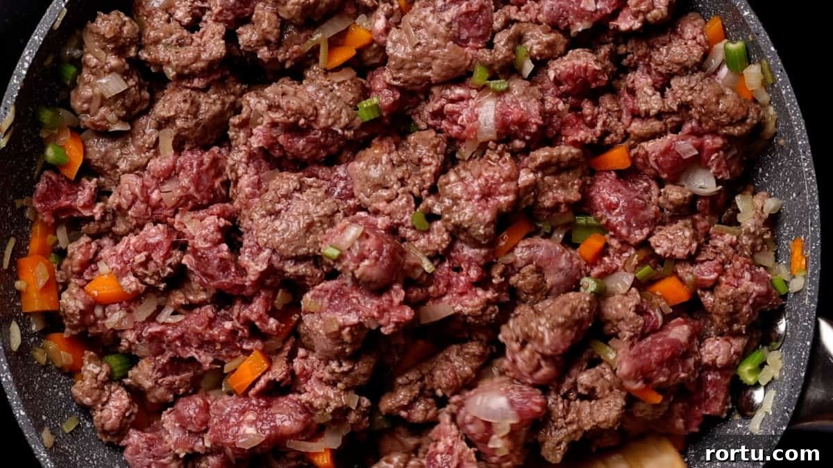 Lamb Ragu Recipe: Slow-Simmered Sauce with Parmesan 7 Browning ground lamb with vegetables.