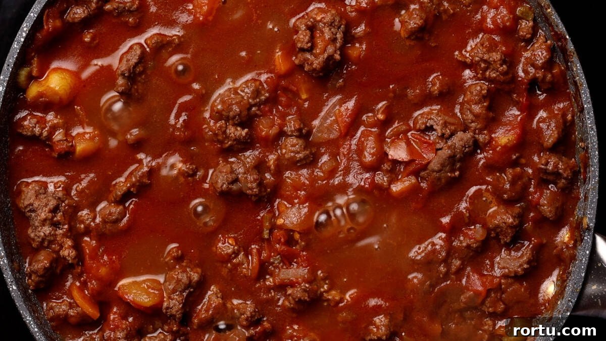 Lamb Ragu Recipe: Slow-Simmered Sauce with Parmesan 9 Simmering lamb ragu ready to serve.