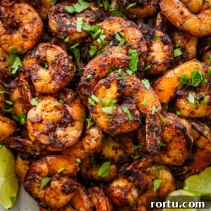 10-Minute Blackened Shrimp Recipe for Flavorful Weeknight Meals 18 Blackened shrimp on a plate with garnish.