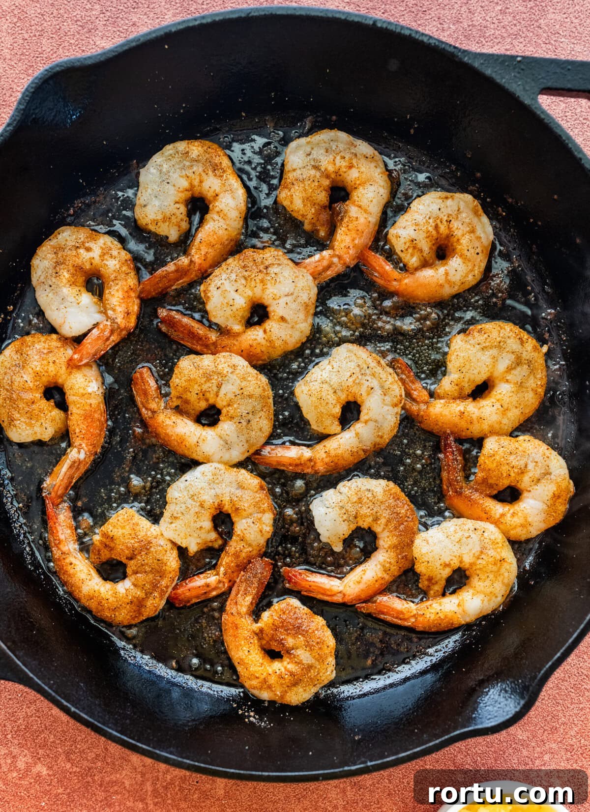10-Minute Blackened Shrimp Recipe for Flavorful Weeknight Meals 9 One layer of shrimp in a skillet.