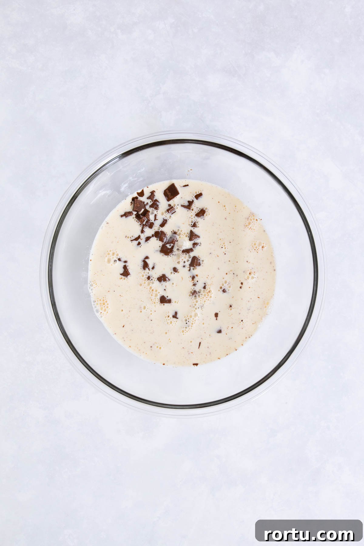 Creamy Baileys Chocolate Mousse Recipe 6 The hot cream poured over the chocolate in the glass bowl.