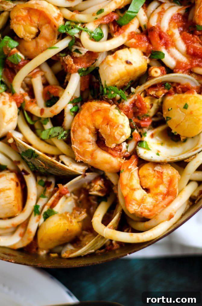 Seafood Fra Diavolo. This pasta dish is impressive for a date night or Valentine's Day dinner but easy enough to make at home! Loaded up with shrimp, scallops, clams, and crab, it doesn't get better than this. | hostthetoast.com