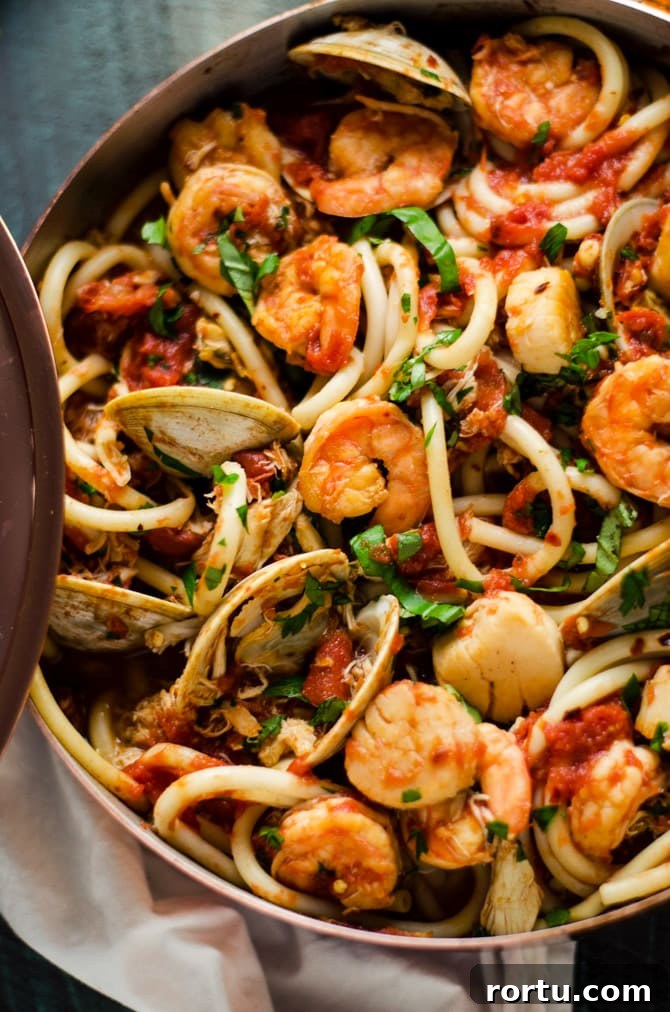 Seafood Fra Diavolo. This pasta dish is impressive for a date night or Valentine's Day dinner but easy enough to make at home! Loaded up with shrimp, scallops, clams, and crab, it doesn't get better than this. | hostthetoast.com