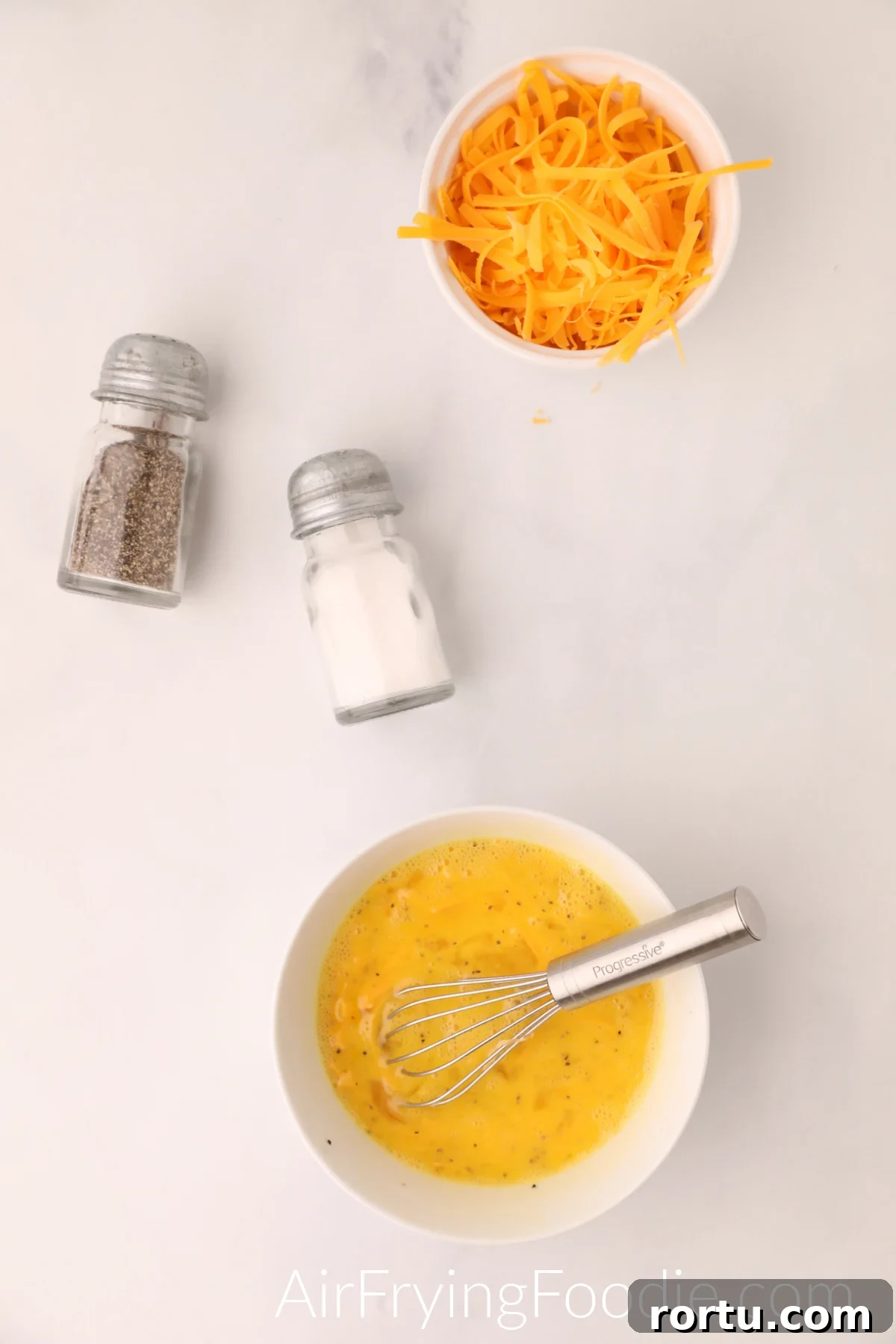 Eggs whisked together in a bowl.