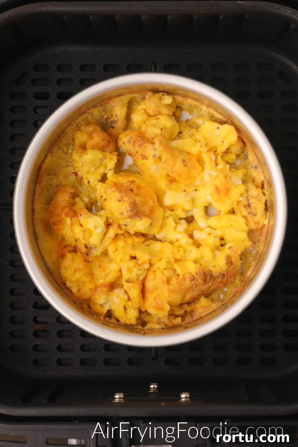 Air Fryer Scrambled Eggs in the air fryer basket.