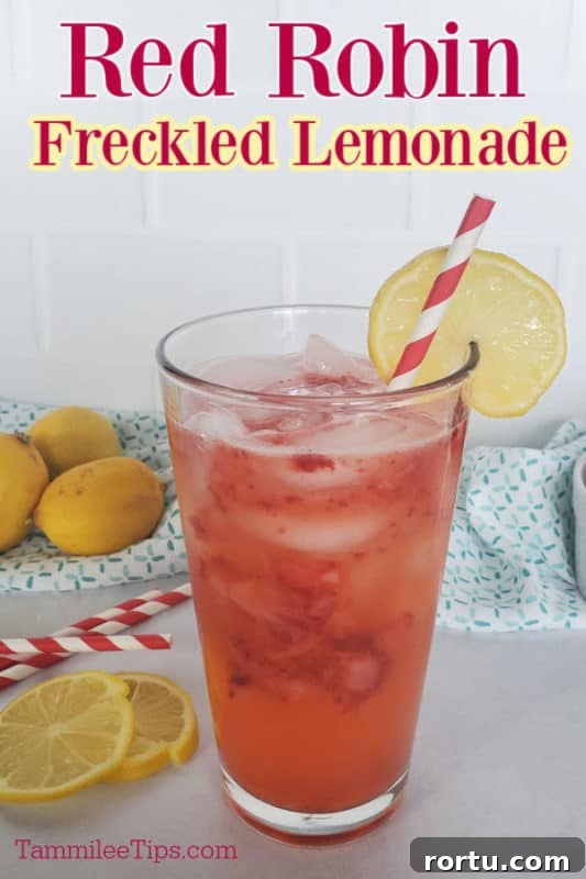 Red Robin Freckled Lemonade text printed over a glass filled with strawberry lemonade and a lemon wheel