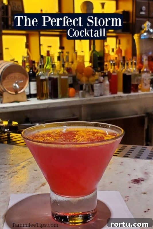 The Perfect Storm Cocktail text printed over a glass with a pink cocktail