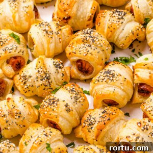 Close up shot of crescent roll hot dogs sprinkled with sesame and poppy seeds.