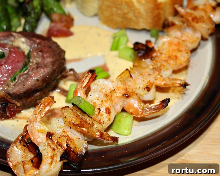 Garlic Butter Grilled Shrimp Skewers servd wtih grilled flank steak pinwheels