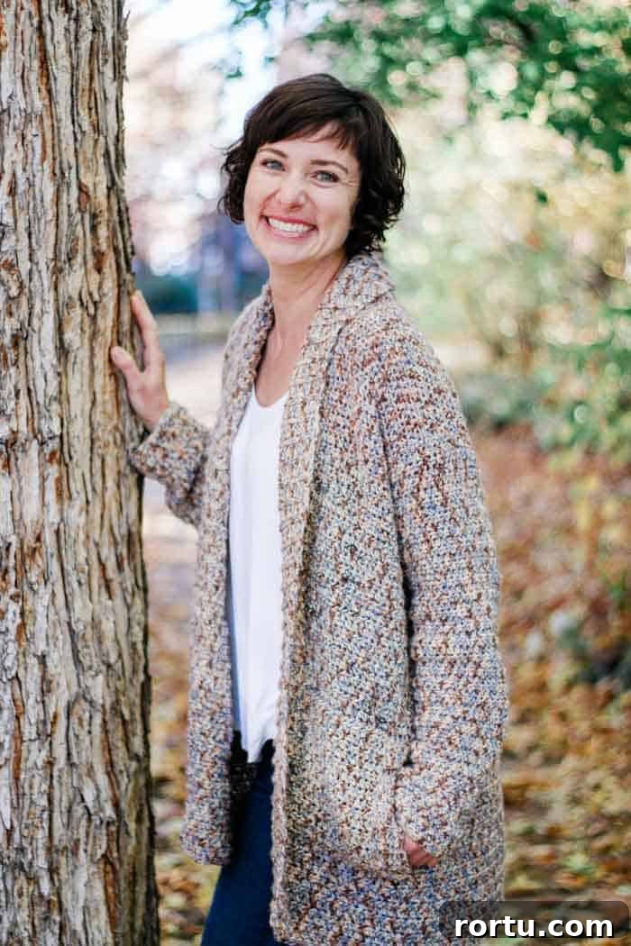 woman wearing beginner cardigan sweater pattern to crochet