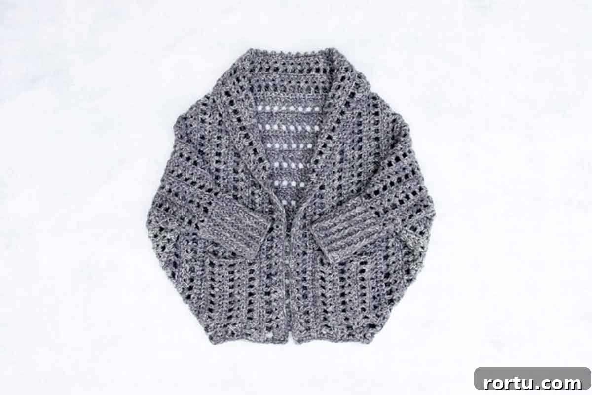 Image shows a gray chunky crochet sweater pattern. -Skip To My Lou